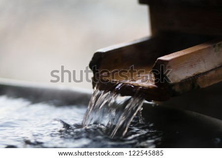 Japanese open air hot spring (onsen) - focus on the flowing water