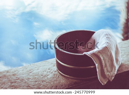Bath bucket with a towel at a hot spring bath at Japanese onsen. Filtered image.