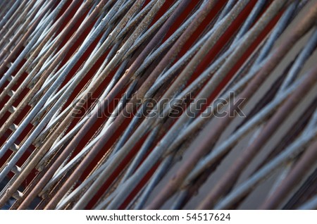 Aluminum and iron bars of a security grill shot at an angle.