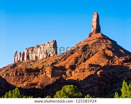 Round Mountain in the Castle Valley near Moab, Utah with Castleton Tower (Castle Rock) and the Priest and Nuns rock formation with deep blue sky