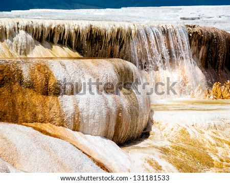 Water pours over a deposited limestone terrace at Mammoth Hot Springs in Yellowstone National Park, Wyoming.