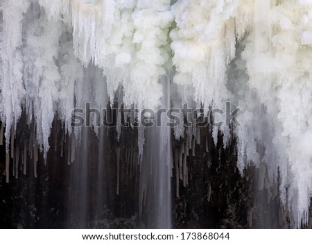 Water falls forming intricate icicle formations at Upper Cataract Falls, a waterfall in Indiana.