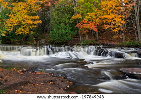 Whitewater cascades over rock ledges at Bond Falls, a beautiful waterfall in Michigan\'s remote Upper Peninsula.