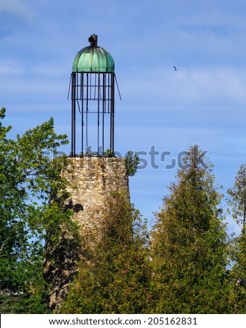 The Old Lighthouse at Baileys Harbor in Door County Wisconsin is one of a handful of existing beacons with a birdcage lantern room. First used in 1853, the landmark has greatly deteriorated.