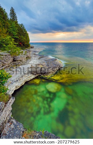 The sun rises over the beautiful and rocky Cave Point on the Lake Michigan coast of Door County, Wisconsin.