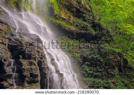 Cathedral Falls, a waterfall in West Virginia\'s scenic New River Gorge is viewed from alongside in late summer.