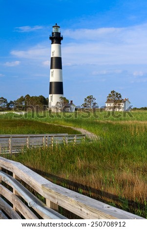 A wooden boardwalk leads to Bodie Island Lighthouse and keepers station at Cape Hatteras National Seashore on North Carolina\'s Outer Banks.
