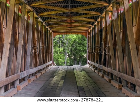 The wooden trusses of the James Covered Bridge are seen from within. The historic bridge crosses Big Graham Creek in rural Jennings County, Indiana.