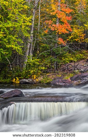 Autumn foliage provides a splash of color at Bond Falls State Park in Michigan\'s rural western Upper Peninsula.