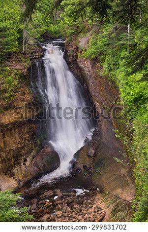 Miners Falls, a beautiful large waterfall at Pictured Rocks National Lakeshore, near Munising in Upper Peninsula Michigan, plunges about fifty feet over a sandstone cliff.