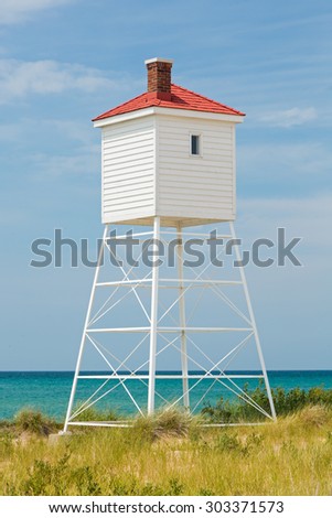The fog horn tower at Michigan\'s Big Sable Point Lighthouse stands over Lake Michigan on a sunny summer day in Ludington State Park.