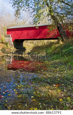 Red Covered Bridge Crossing Ramp Creek in Autumn in Brown County State Park, Indiana