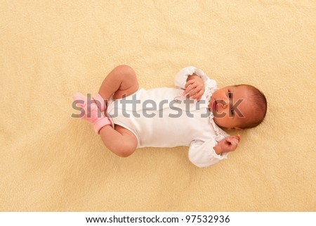 portrait of lovely newborn lying on the back top-up view