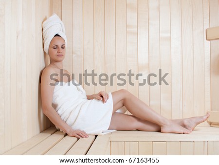 beautiful young woman relaxing in finnish sauna