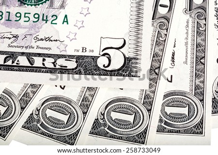 One dollar banknotes and five dollar bill abstract background.