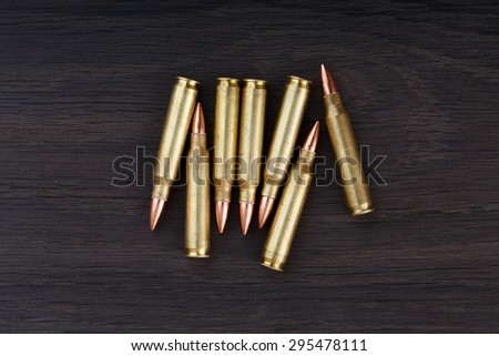 Old ammunition on the wood background. Army equipment.