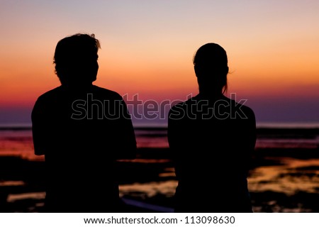couple watching beautiful bright sunset under ocean