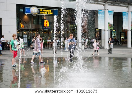 HONG KONG - APRIL 10: People playing with The Water fountain outside Tung Chung MTR in Lantau Island, Hong Kong on April 10 2011. The Water Fountain is popular tourist attraction.