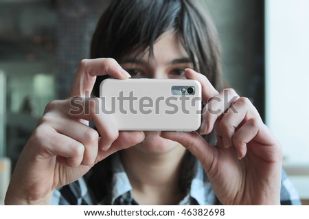 young woman taking photos, mobile camera