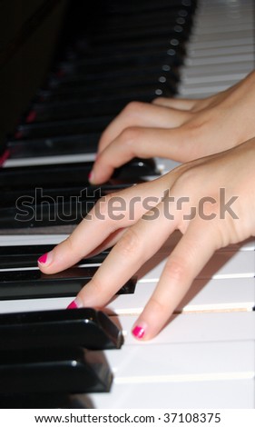 child\'s hands on piano keyboard in perspective