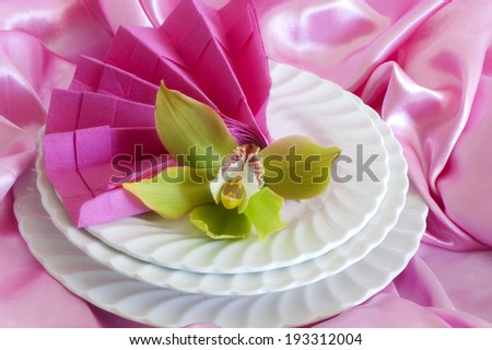 Elegant origami napkins to decorate the table on fabric background
