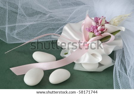 candy wedding favors and packaging materials on a green background