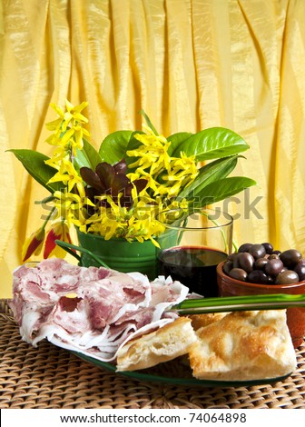 Typical Italian sausage sliced ??cake and flowers