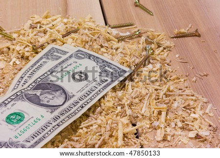small salary and hard work. money and sawdust in carpenters workshop