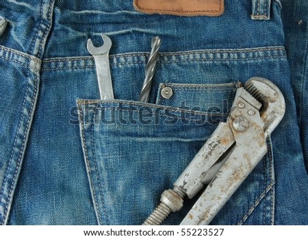 work tools in jeans back pocket. Work wear theme