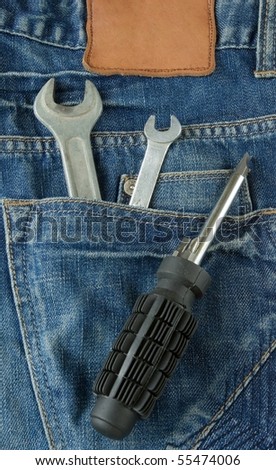 Toolkit in jeans pocket. Repairman work wear theme.