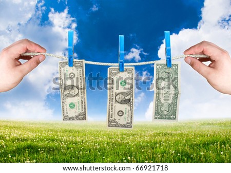 Money on the rope with hand. money laundering theme