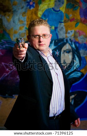 stylish man aiming with gun