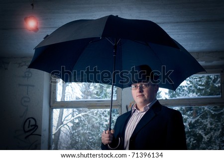man with umbrella in old building. Conceptual creative idea image