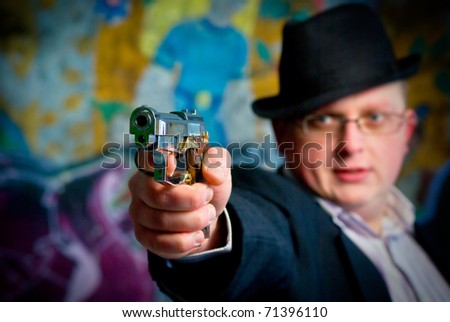 man aiming with gun. Close-up shot on gun