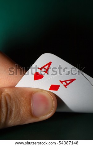 Fingers holding winning cards
