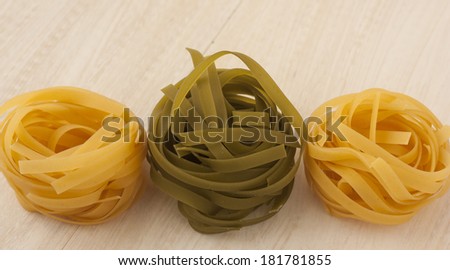 Pasta tagliatelle italian noodles two colors.