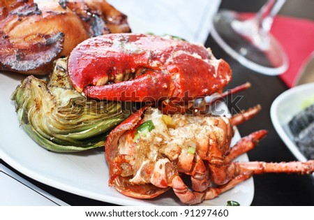 Close up of roasted lobster with artichokes.