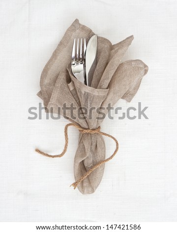 Knife and fork table setting with natural linen