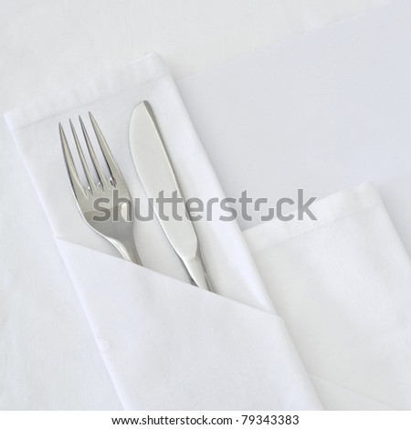 Table setting with blank menu card with white linen