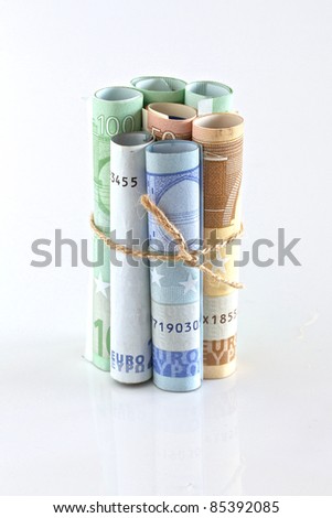 Euro crisis.Euro bills rolled up and tied with string and isolated. Money is tied up or tight concept