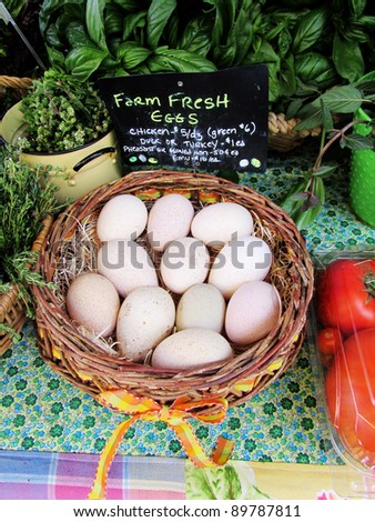 Basket of organic farm eggs, with herbs at an organic farmers market