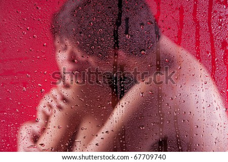 stock photo Naked lovers in hug behind wet glass