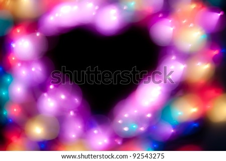 Beautiful de-focused glitter lights in heart shape. Nothing is in focus!