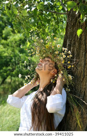 young woman in the forest with diadem with wild flowers