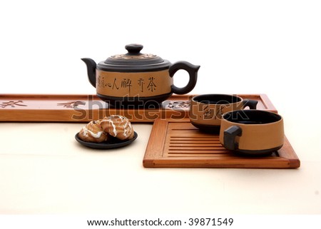 Chinese teapot, tea, cookies on the tea-table