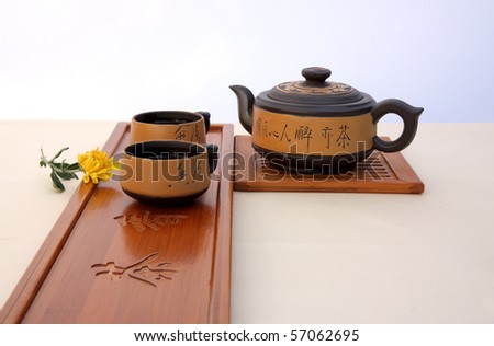 Chinese teapot, tea and  yellow chrysanthemum on the tea-table