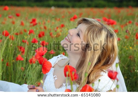 Happy beauty bride in the poppies field
