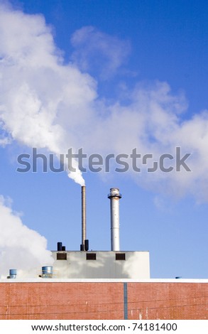 Smokestacks and pollution from industrial paper mill vertical