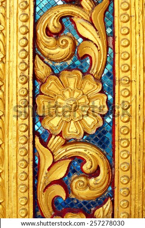 golden flower pattern on the temple door-frame.