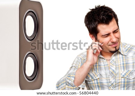 portrait of unhappy man plugging his ear from noise